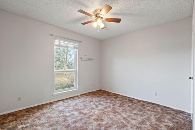 carpeted spare room with a textured ceiling, a ceiling fan, and baseboards