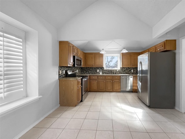 2809 Silverspring Rd, Carrollton, TX 75006 - kitchen featuring appliances with stainless steel finishes, brown cabinetry, decorative backsplash, lofted ceiling, and a sink
