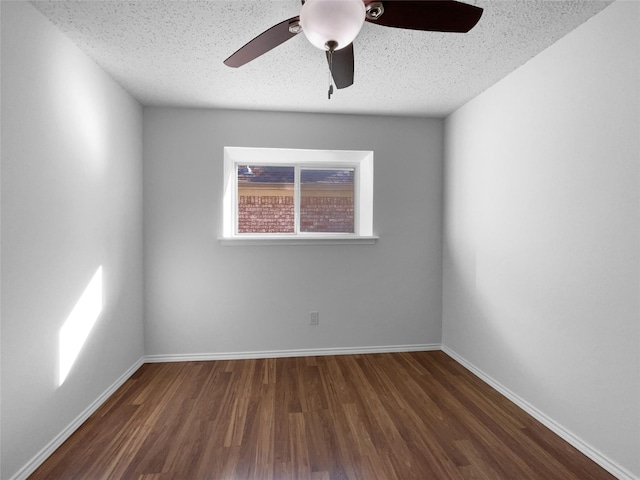 unfurnished room featuring ceiling fan, a textured ceiling, baseboards, and wood finished floors