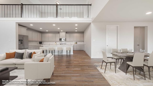 4343 Hudson St, Fate, TX 75087 - living room with light wood finished floors, recessed lighting, and a towering ceiling
