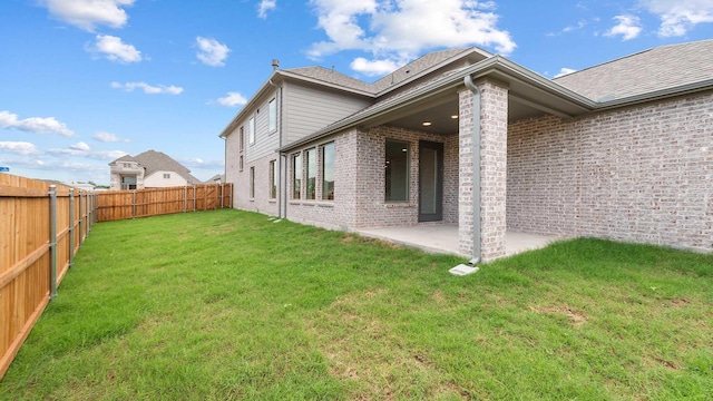 4343 Hudson St, Fate, TX 75087 - back of property with brick siding, a patio, a fenced backyard, and roof with shingles