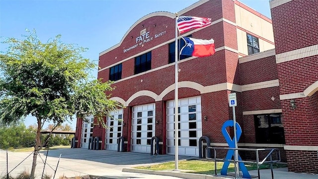 view of building exterior with driveway and an attached garage