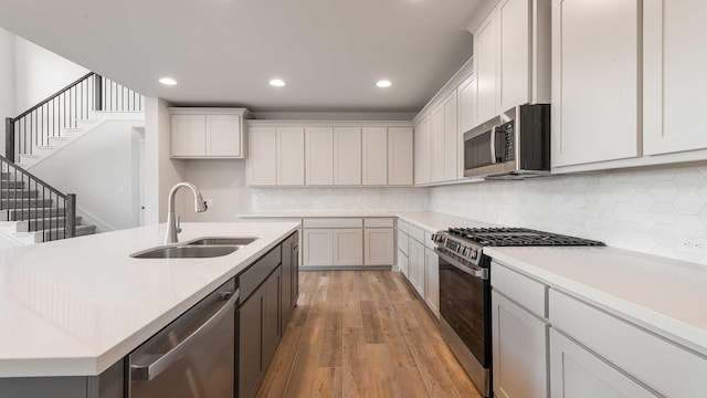 4343 Hudson St, Fate, TX 75087 - kitchen with stainless steel appliances, light countertops, recessed lighting, light wood-style flooring, and tasteful backsplash