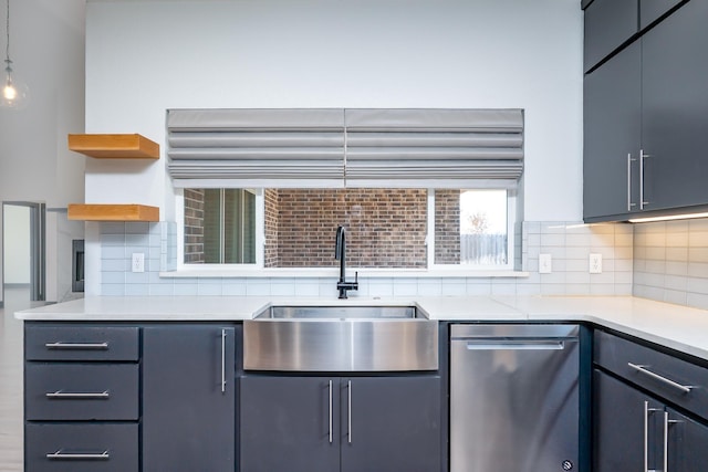 kitchen with light countertops, a sink, stainless steel dishwasher, and open shelves