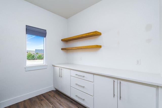 interior space featuring dark wood finished floors and baseboards