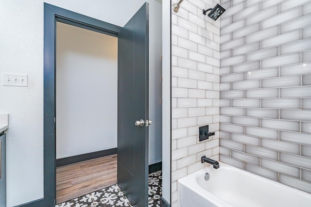 full bathroom with shower / tub combination, baseboards, and wood finished floors