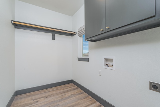 laundry room with baseboards, washer hookup, cabinet space, and hookup for an electric dryer