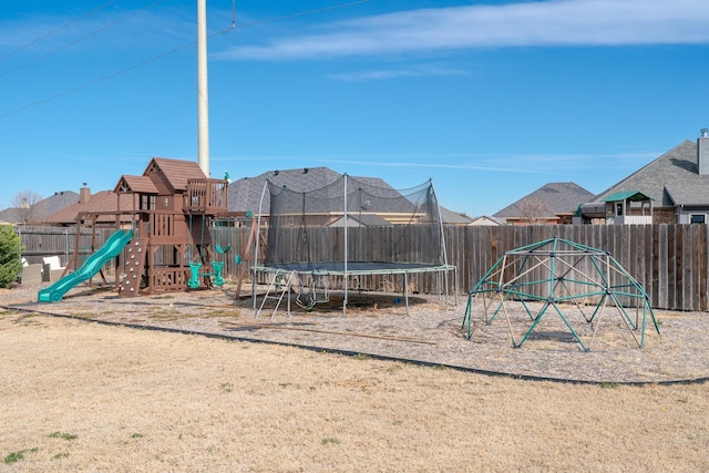 view of playground featuring a fenced backyard and a trampoline