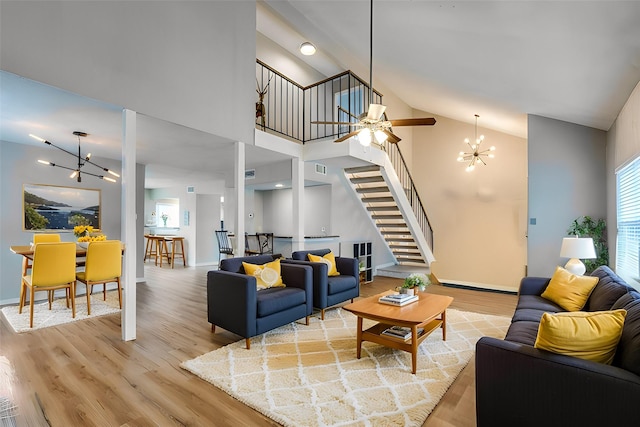 2520 Via Avenida Dr, Carrollton, TX 75006 - living room with stairs, a chandelier, wood finished floors, baseboards, and high vaulted ceiling