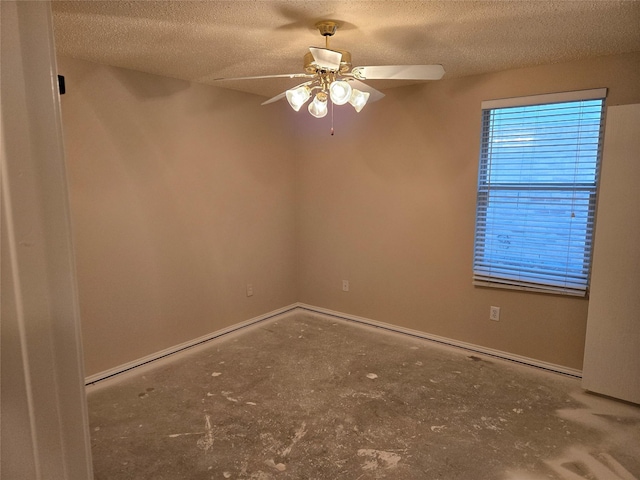 empty room featuring a textured ceiling, ceiling fan, and baseboards