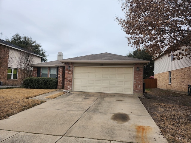 view of front of house with a garage, a chimney, concrete driveway, and brick siding