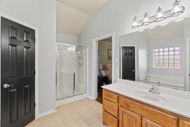 ensuite bathroom featuring lofted ceiling, tile patterned flooring, connected bathroom, a sink, and a shower stall