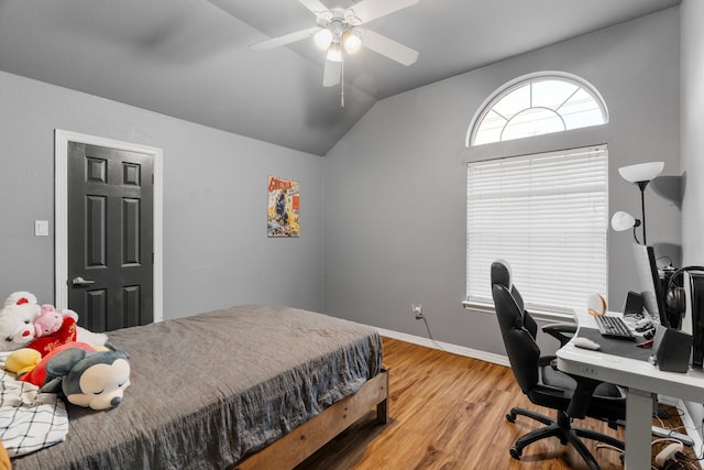 bedroom with vaulted ceiling, light wood-style flooring, baseboards, and ceiling fan