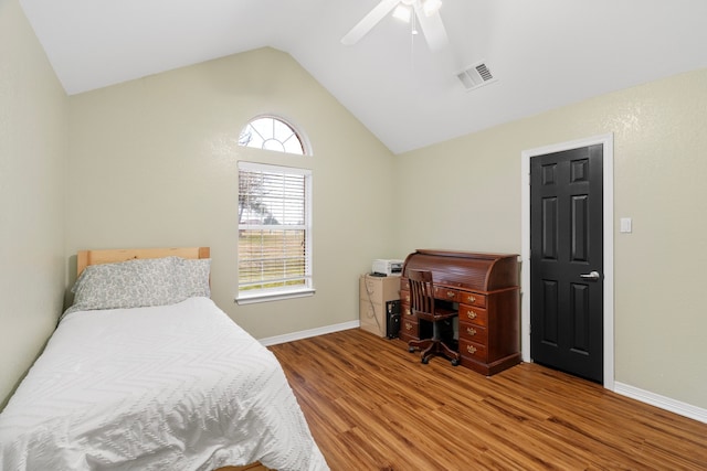 bedroom featuring visible vents, vaulted ceiling, baseboards, and wood finished floors