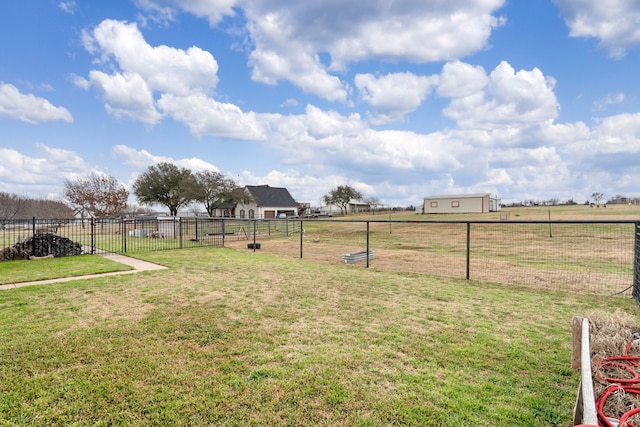 view of yard with fence and a rural view