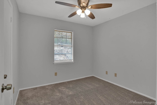 carpeted spare room with ceiling fan and baseboards