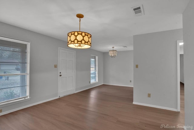 foyer entrance with visible vents, baseboards, and wood finished floors