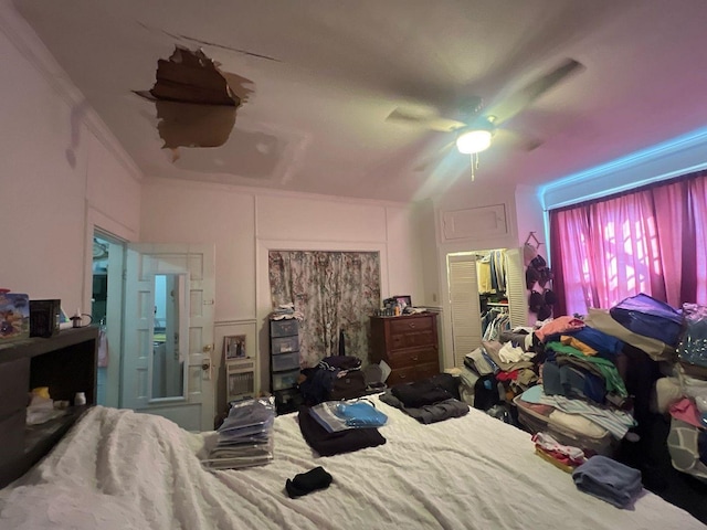 bedroom featuring ceiling fan and crown molding