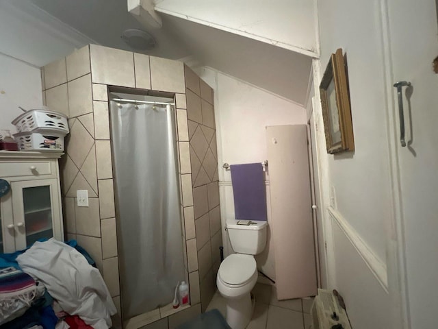 bathroom featuring radiator, a shower with curtain, toilet, tile patterned flooring, and tile walls