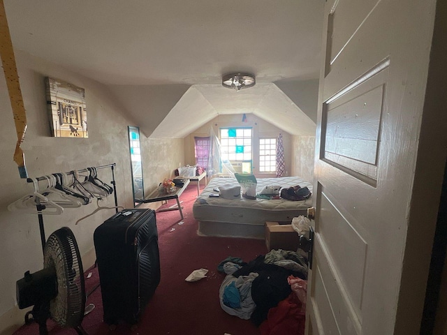 bedroom featuring lofted ceiling and carpet