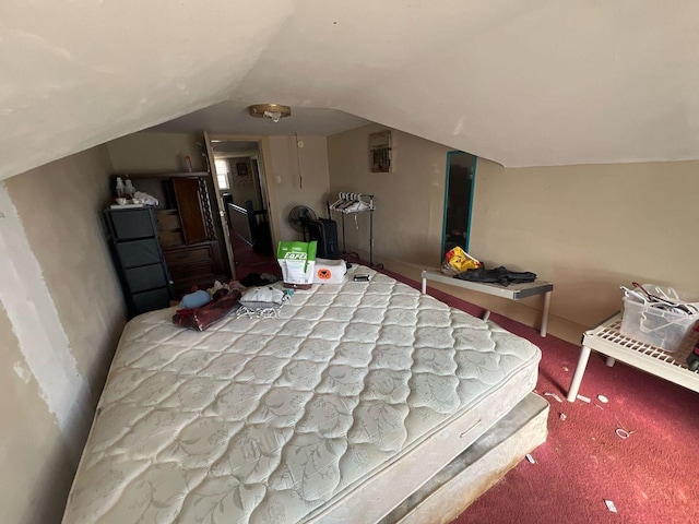 bedroom with carpet and lofted ceiling