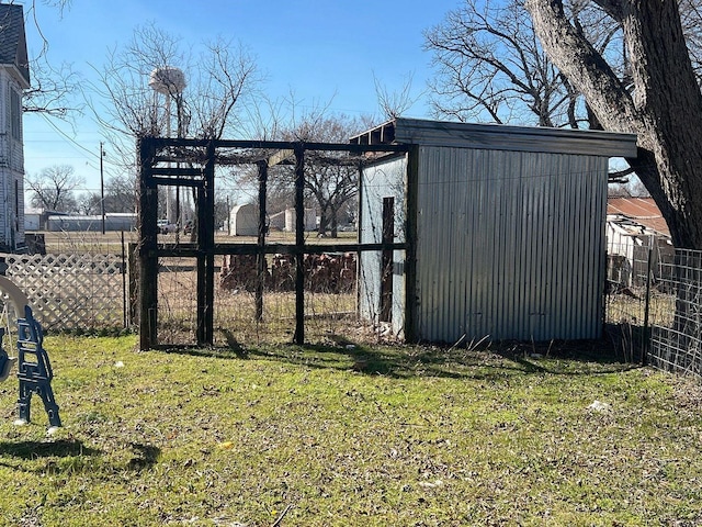 view of outbuilding featuring an outbuilding and fence