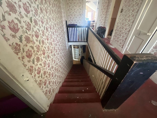 staircase featuring wallpapered walls