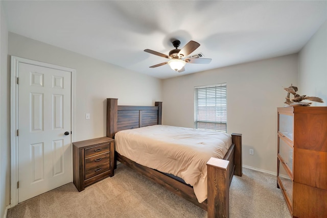 bedroom with light carpet and a ceiling fan