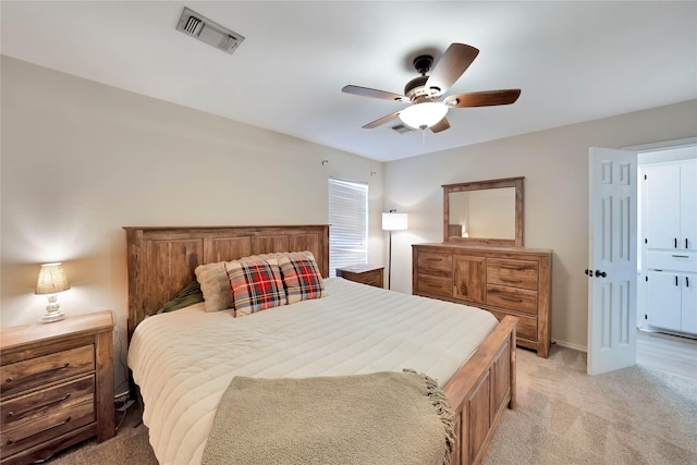 bedroom with a ceiling fan, light colored carpet, visible vents, and baseboards