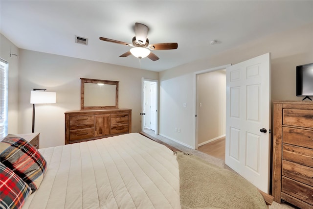 bedroom featuring baseboards, visible vents, and a ceiling fan