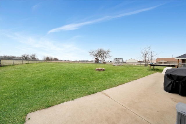 view of yard featuring an outdoor fire pit and fence