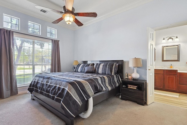 bedroom featuring light carpet, ornamental molding, and multiple windows