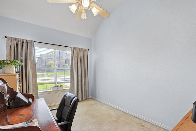 office area with light carpet, lofted ceiling, a ceiling fan, and baseboards