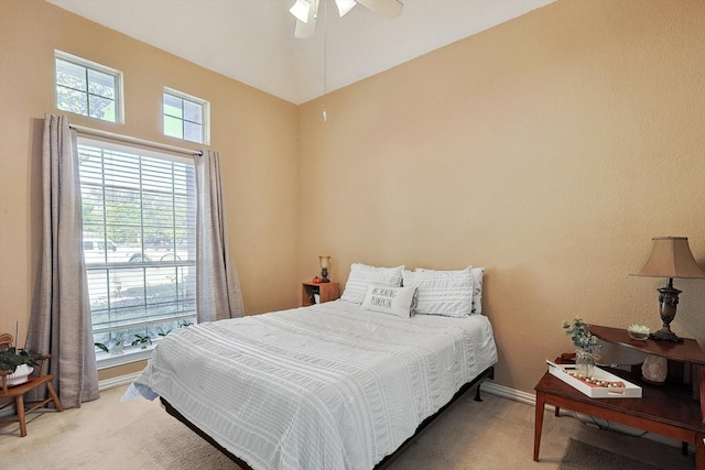 carpeted bedroom with baseboards and a ceiling fan