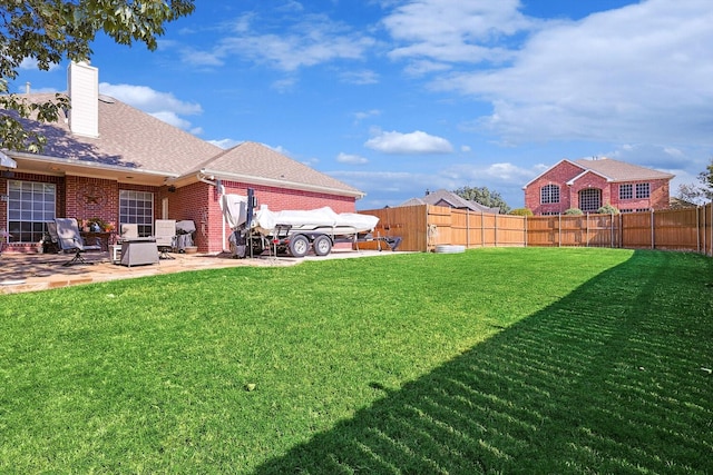 view of yard with a patio area and a fenced backyard