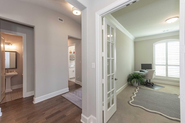 home office featuring ornamental molding, visible vents, baseboards, and wood finished floors