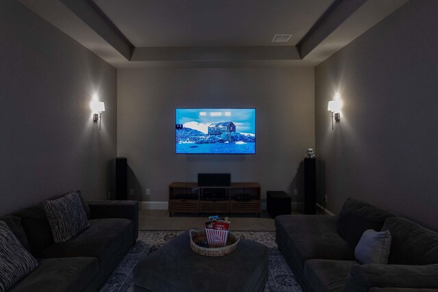 cinema featuring visible vents, baseboards, and a tray ceiling