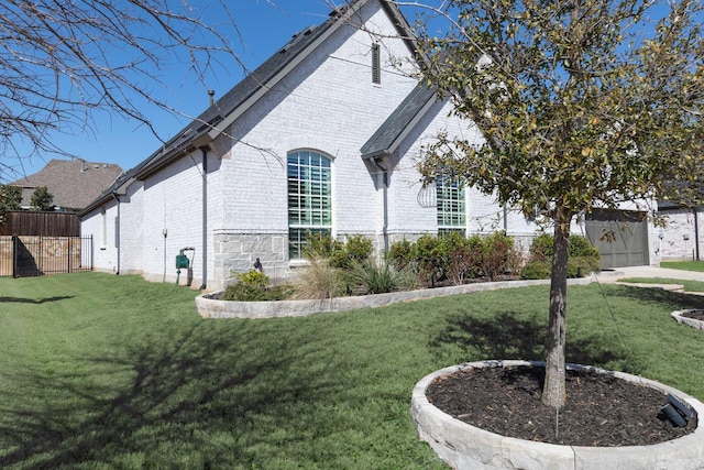 view of home's exterior featuring a lawn and brick siding
