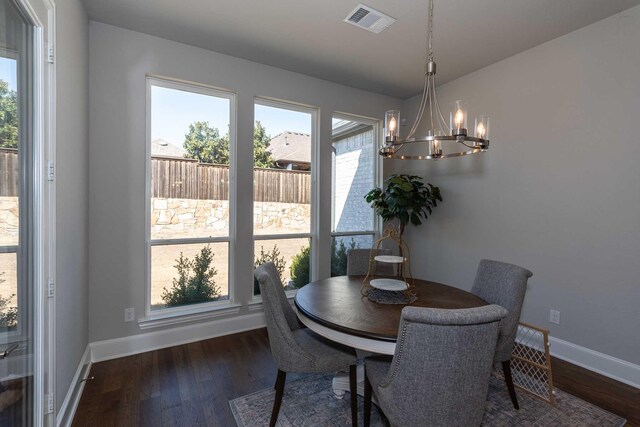 kitchen featuring tasteful backsplash, white cabinets, stainless steel gas cooktop, and under cabinet range hood