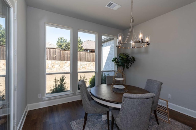 dining room with baseboards, visible vents, dark wood-style flooring, and a wealth of natural light