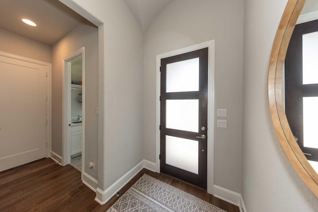 foyer with recessed lighting, dark wood-style flooring, and baseboards