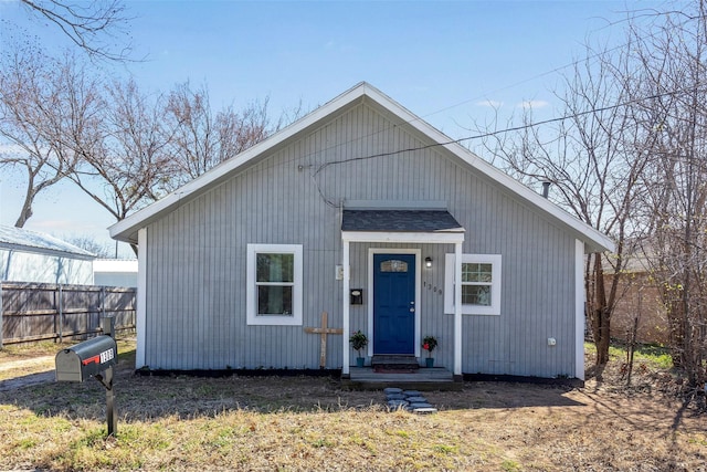 bungalow-style home with fence