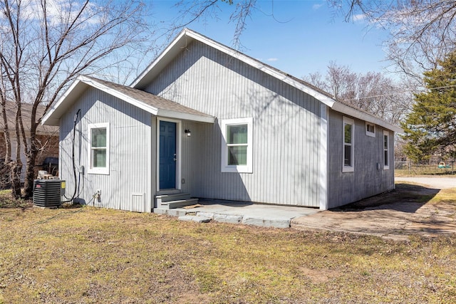 1309 Nugent St, Bowie, TX 76230 - back of house with entry steps, central AC, and a yard