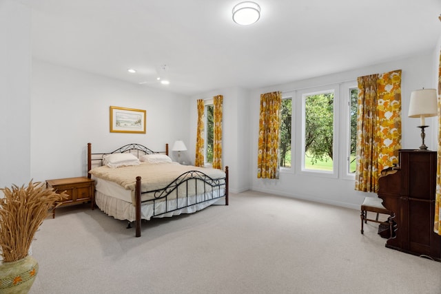 carpeted bedroom featuring baseboards and recessed lighting