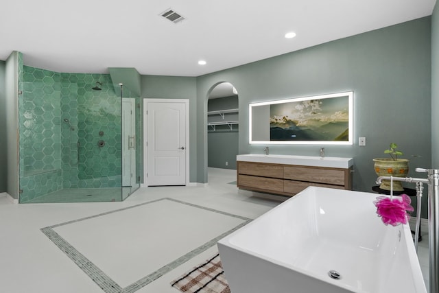 bathroom with recessed lighting, visible vents, a shower stall, vanity, and a freestanding tub