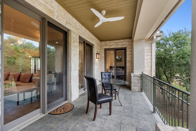 balcony featuring ceiling fan and a sunroom