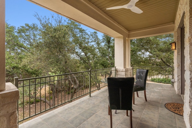 view of patio / terrace with a balcony and ceiling fan