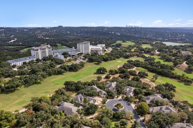 birds eye view of property with a view of city and golf course view