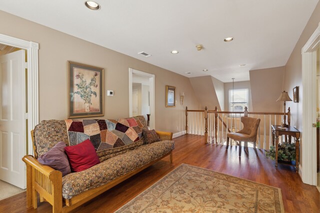 living room with baseboards, wood finished floors, visible vents, and recessed lighting