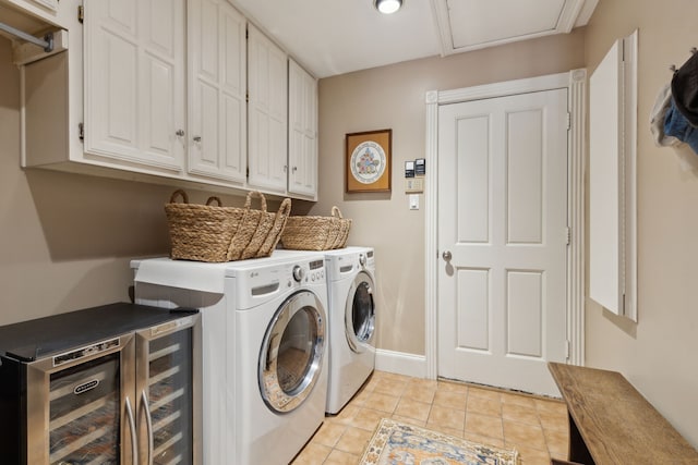 laundry area with light tile patterned flooring, beverage cooler, separate washer and dryer, baseboards, and cabinet space